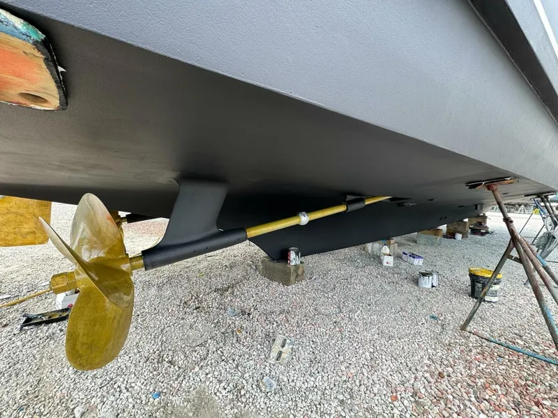 Slide: The Image of 1985 Hatteras Enclosed Bridge yacht underbody with propeller and shaft on dry dock. - 40