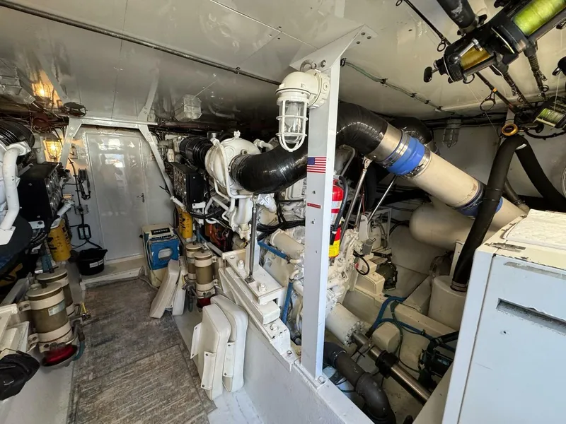 Slide: The Image of Engine room of a 1985 Hatteras Enclosed Bridge yacht, showcasing machinery and equipment. - 43