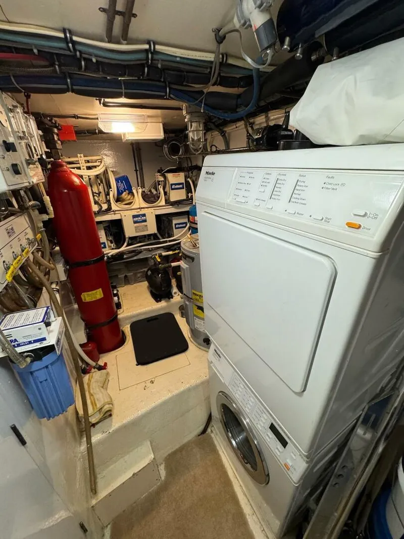 Slide: The Image of Engine room of 1985 Hatteras Enclosed Bridge with laundry appliances and equipment. - 47