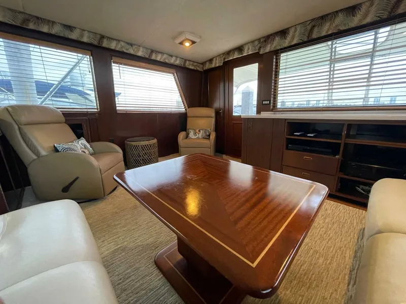 Slide: The Image of Luxurious interior of 1985 Hatteras Enclosed Bridge yacht with elegant wood furnishings. - 5