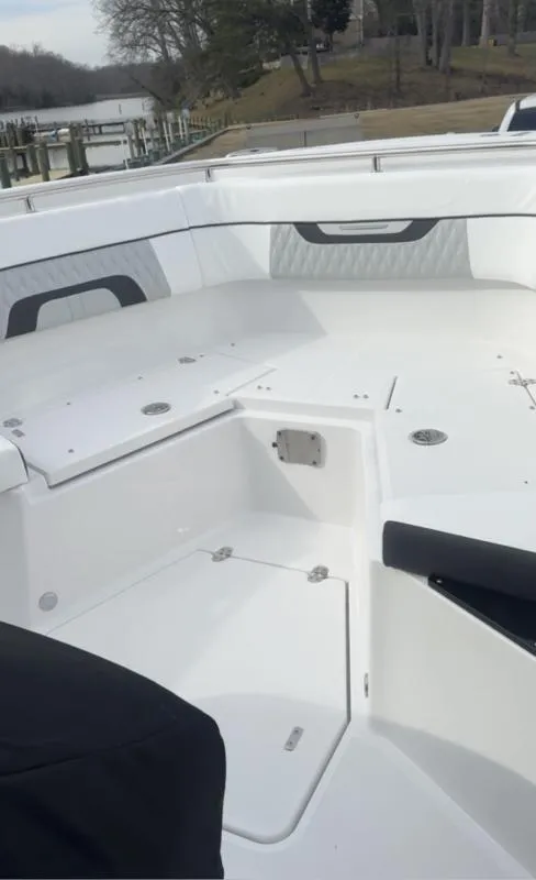 Slide: The Image of 2024 Blackfin 272 boat interior with sleek white seating and storage compartments. - 6