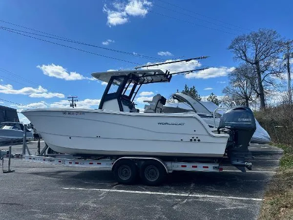 Slide: The Image of 2023 World Cat 260 CC-X boat on trailer, parked outdoors under a blue sky. - 1