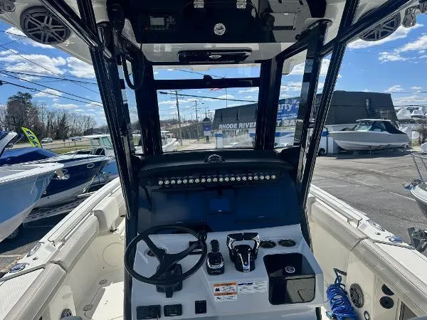 Slide: The Image of 2023 World Cat 260 CC-X boat interior with steering console and controls. - 10