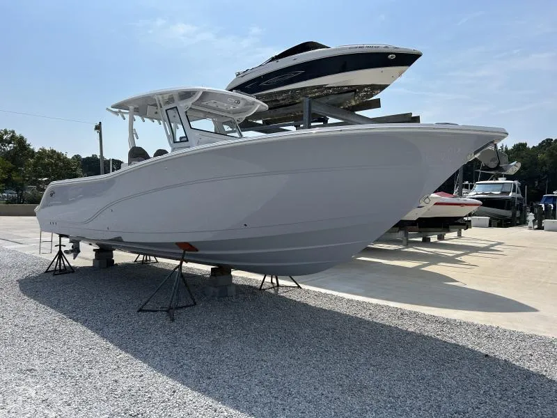 Slide: The Image of 2024 Sea Fox 328 Commander boat displayed on gravel lot under clear sky. - 3