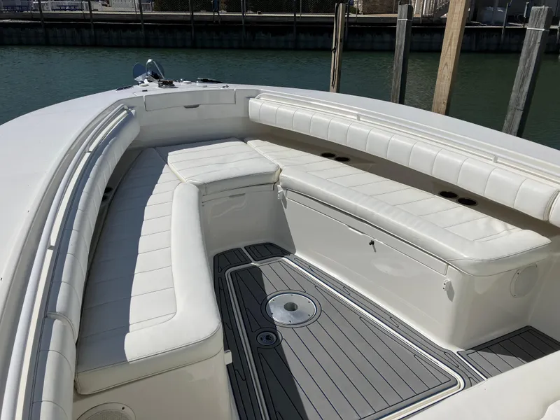 Slide: The Image of 2013 Regulator 28 boat with white cushioned seating and sleek deck design. - 17