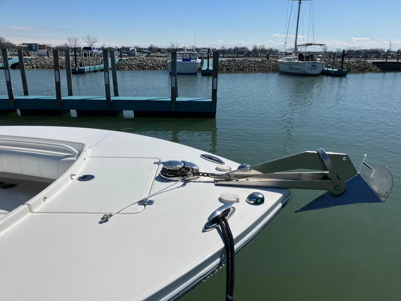 Slide: The Image of 2013 Regulator 28 boat anchored at a marina with calm water. - 18