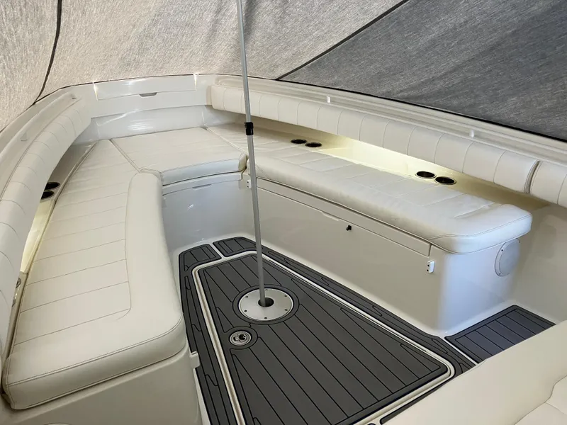 Slide: The Image of 2013 Regulator 28 boat interior with white seating and gray flooring. - 19