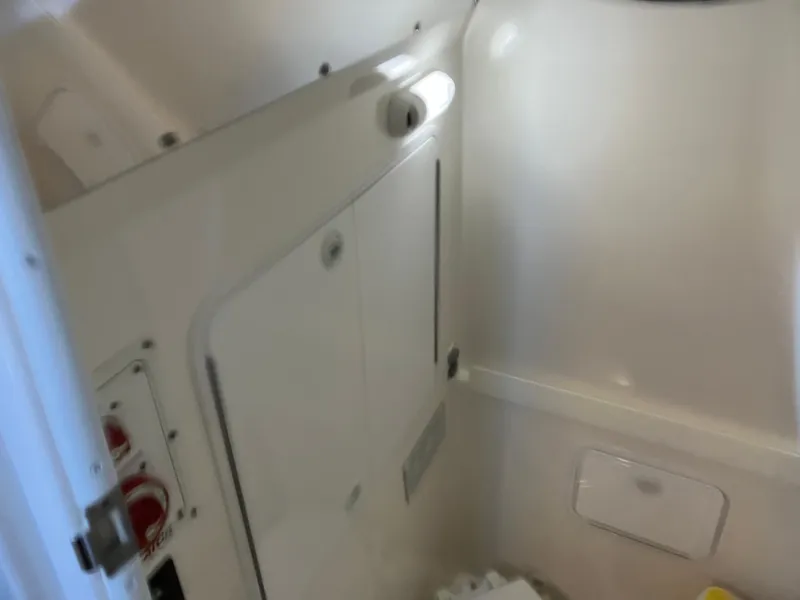 Slide: The Image of 2013 Regulator 28 boat interior cabin with storage compartments. - 21