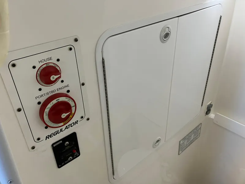Slide: The Image of 2013 Regulator 28 boat control panel with switches and storage compartment. - 22