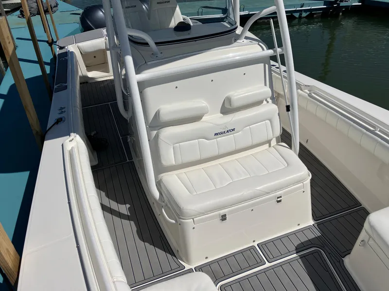 Slide: The Image of 2013 Regulator 28 boat interior with white seating and sleek design. - 26