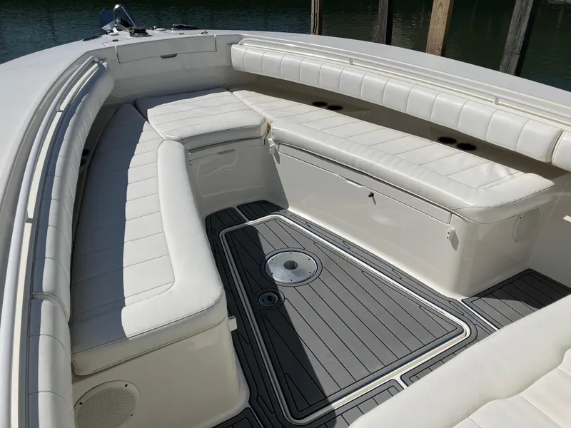Slide: The Image of 2013 Regulator 28 boat with white cushioned seating and sleek deck design. - 27