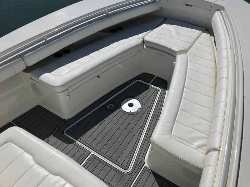 Slide: The Image of 2013 Regulator 28 boat interior with white cushioned seating and sleek flooring. - 28