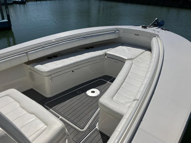 Slide: The Image of 2013 Regulator 28 boat interior with white cushioned seating and sleek design. - 29