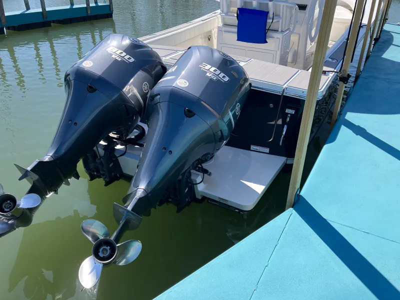 Slide: The Image of 2013 Regulator 28 boat with twin 300 horsepower outboard engines docked. - 35