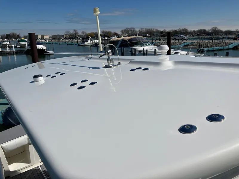 Slide: The Image of 2013 Regulator 28 boat deck with marina background, clear sky, and docked boats. - 37