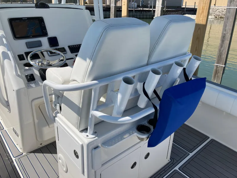 Slide: The Image of 2013 Regulator 28 boat cockpit with dual seats, rod holders, and navigation equipment. - 9
