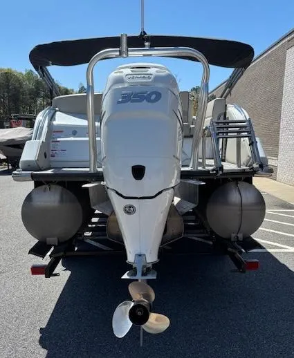Slide: The Image of 2019 Crest Savannah 250 SLS pontoon boat with powerful 350 engine, parked outdoors. - 4