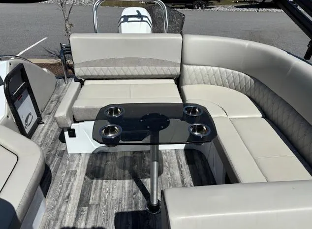 Slide: The Image of Luxurious seating area on 2019 Crest Savannah 250 SLS pontoon boat with cup holders. - 6