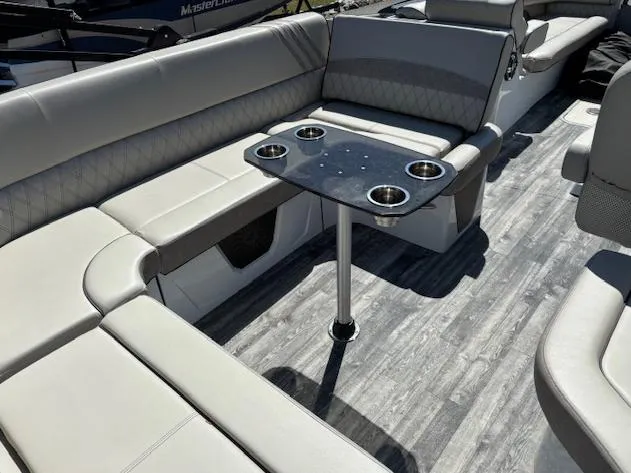 Slide: The Image of Luxurious seating area on 2019 Crest Savannah 250 SLS boat with cupholders and sleek flooring. - 7