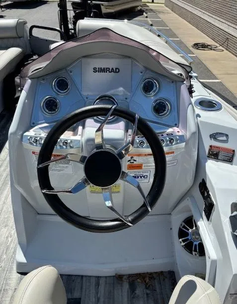 Slide: The Image of 2019 Crest Savannah 250 SLS boat dashboard with Simrad display and steering wheel. - 8
