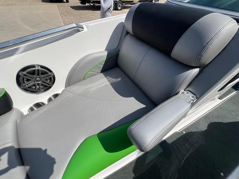 Slide: The Image of 2013 MasterCraft X-25 boat interior with gray and green seating, featuring a JL Audio speaker. - 15