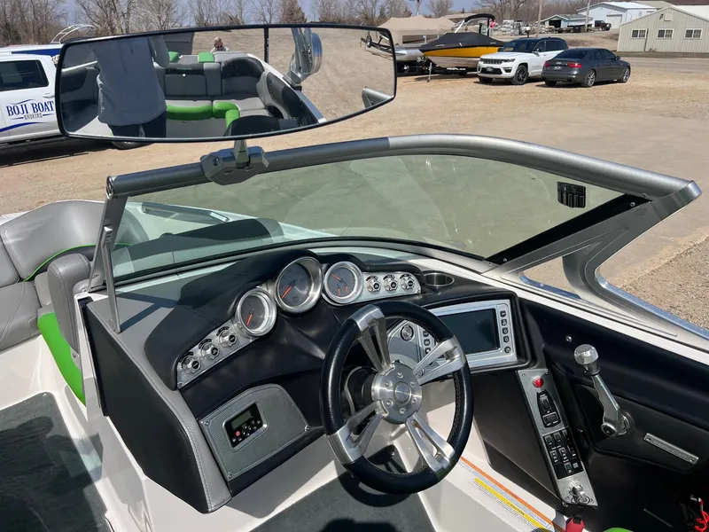 Slide: The Image of 2013 MasterCraft X-25 boat dashboard with steering wheel and control panel. - 19