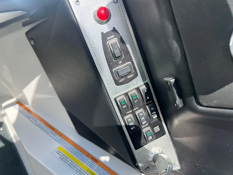 Slide: The Image of Control panel of a 2013 MasterCraft X-25 boat with switches and key ignition. - 22