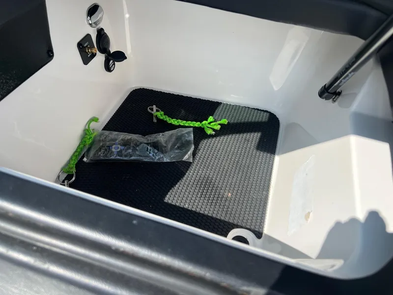 Slide: The Image of Storage compartment of a 2013 MasterCraft X-25 boat with green ropes and accessories. - 26