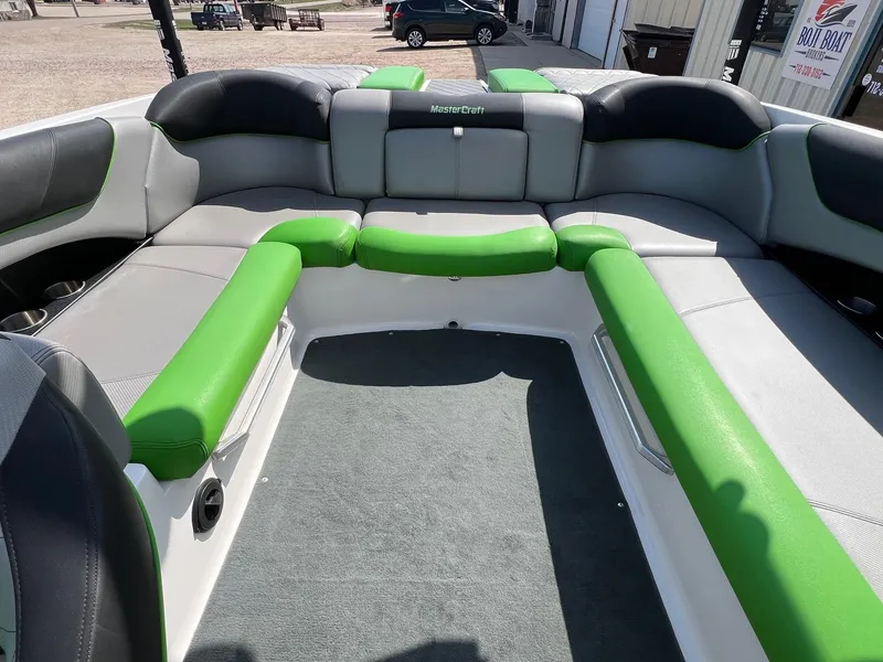 Slide: The Image of 2013 MasterCraft X-25 boat interior with green and gray seating. - 30