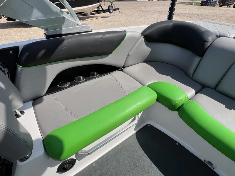 Slide: The Image of 2013 MasterCraft X-25 boat interior with green and gray seating. - 31