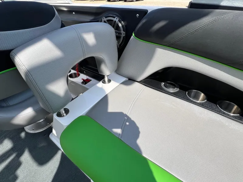 Slide: The Image of 2013 MasterCraft X-25 interior with gray and green seating, cup holders, and speaker. - 32