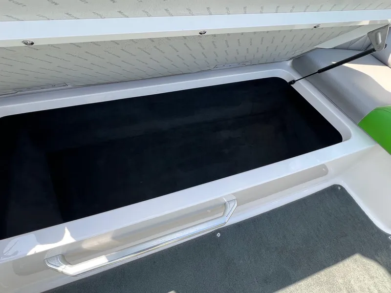 Slide: The Image of Open storage compartment in a 2013 MasterCraft X-25 boat, featuring a sleek design. - 34