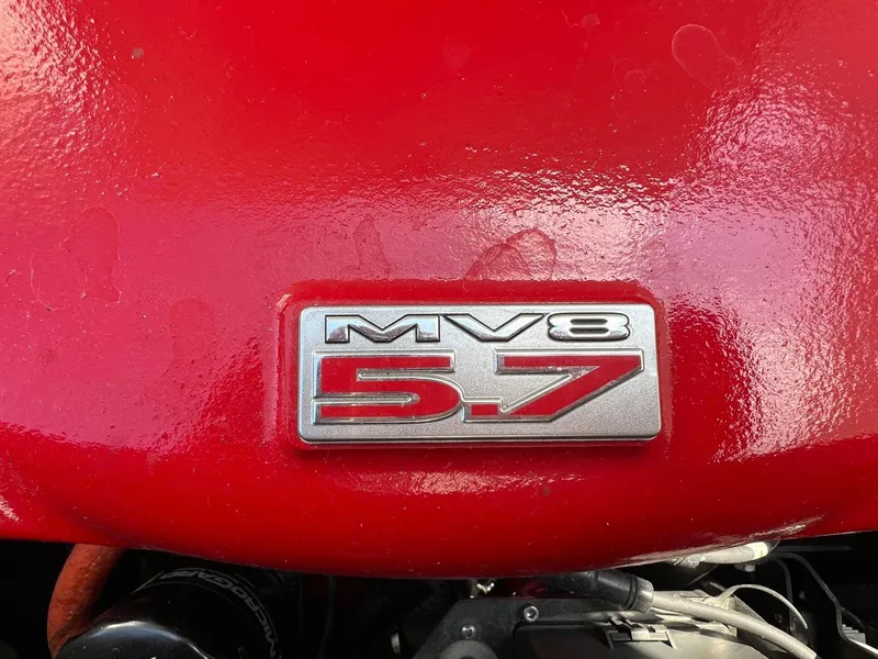 Slide: The Image of Red engine cover with "MV8 5.7" badge on a 2013 MasterCraft X-25. - 39