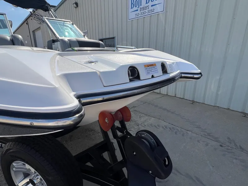 Slide: The Image of 2013 MasterCraft X-25 boat on trailer, parked near a building. - 4