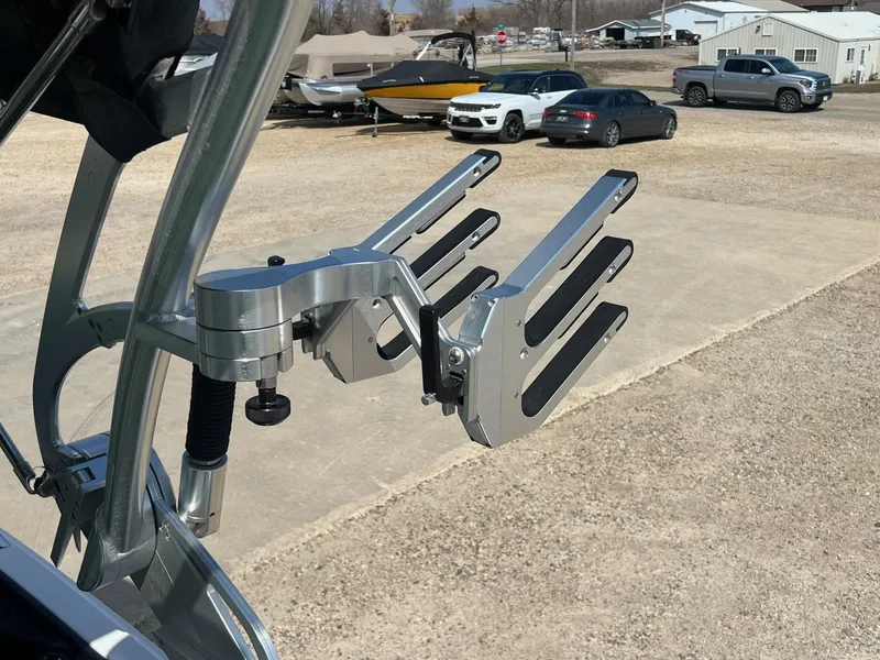 Slide: The Image of 2013 MasterCraft X-25 wakeboard rack in a parking lot with cars and boats. - 45