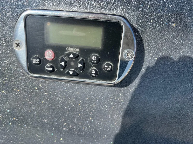 Slide: The Image of Clarion audio control panel on 2013 MasterCraft X-25 boat dashboard. - 48