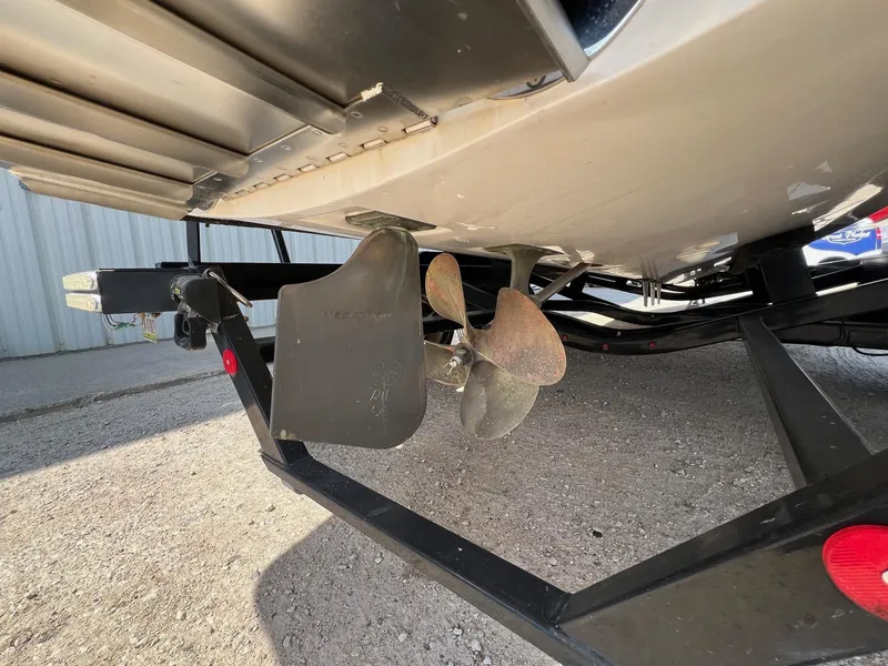 Slide: The Image of 2013 MasterCraft X-25 boat propeller and trailer detail, parked on gravel. - 9