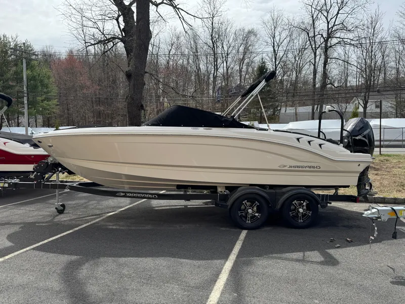 The Image of 2025 Chaparral 21 SSi OB boat on trailer, parked outdoors in a lot. - 1