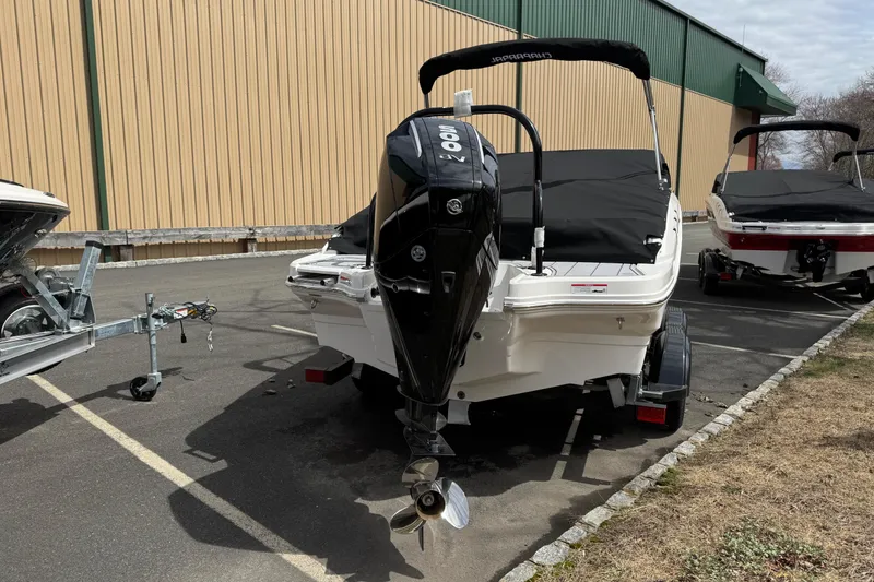Slide: The Image of 2025 Chaparral 21 SSi OB boat with outboard motor, parked outdoors. - 5