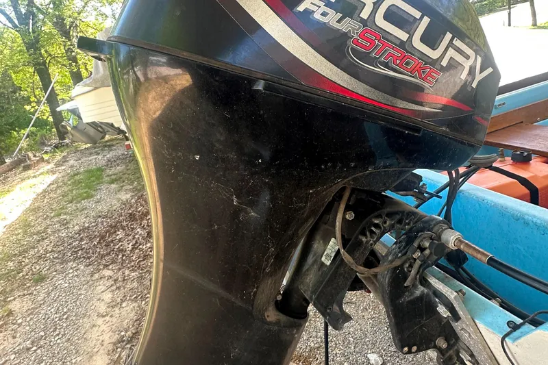 Slide: The Image of Outboard motor on a 1967 Boston Whaler 13, featuring Mercury FourStroke engine. - 12