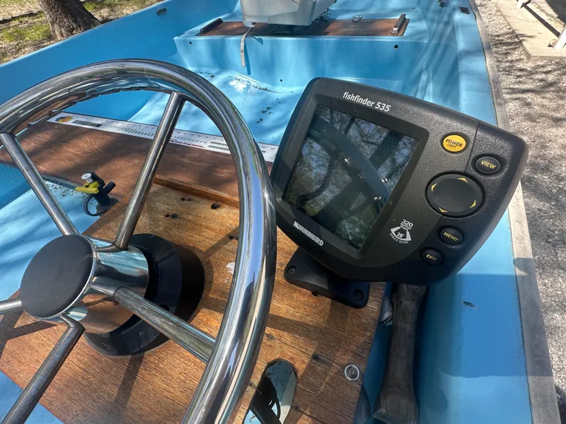 Slide: The Image of Steering wheel and fishfinder on a 1967 Boston Whaler 13 boat. - 7