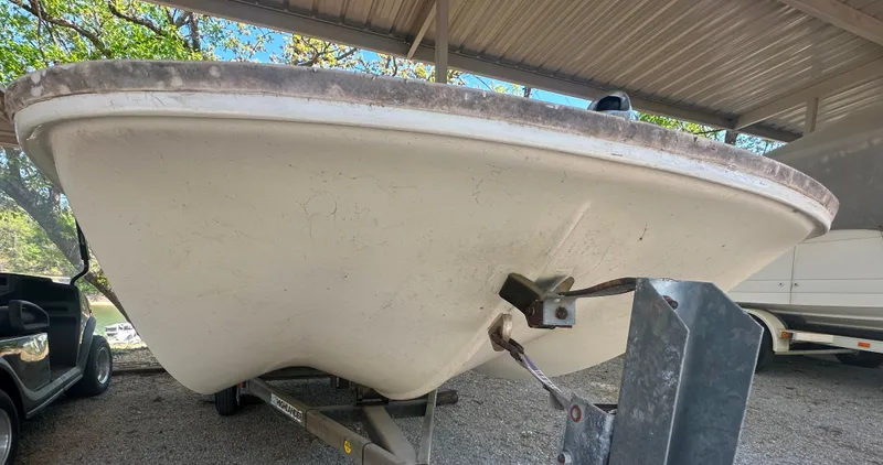 Slide: The Image of 1967 Boston Whaler 13 boat on trailer under shelter, viewed from front. - 8