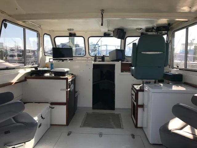 Slide: The Image of Interior of a 1999 Provincial 42 Fishing Boat with seating and navigation equipment. - 10