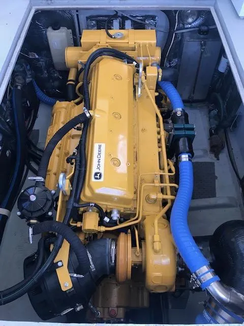 Slide: The Image of Engine compartment of a 1999 Provincial 42 Fishing Boat with a yellow marine engine. - 11