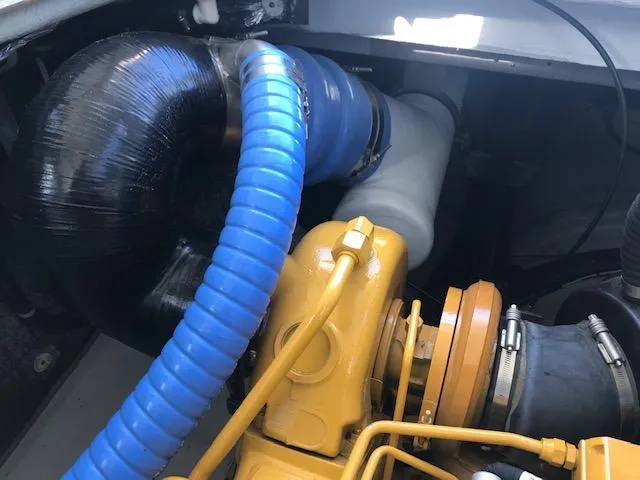 Slide: The Image of Engine compartment of a 1999 Provincial 42 Fishing Boat with visible hoses and components. - 12