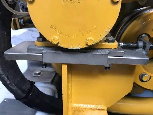 Slide: The Image of Yellow engine component on a 1999 Provincial 42 Fishing Boat, featuring metal brackets and bolts. - 18