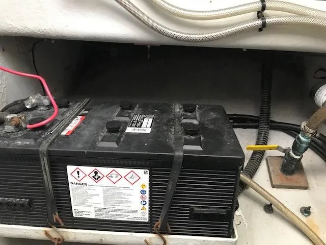 Slide: The Image of Battery compartment of a 1999 Provincial 42 Fishing Boat, showing wiring and safety labels. - 20