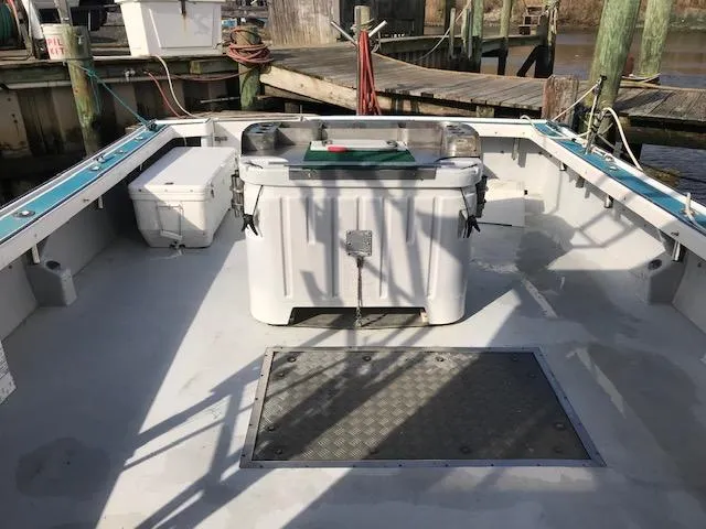 Slide: The Image of 1999 Provincial 42 Fishing Boat deck with storage and equipment, docked at a marina. - 21