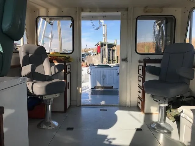 Slide: The Image of Interior of a 1999 Provincial 42 Fishing Boat with two swivel chairs. - 9