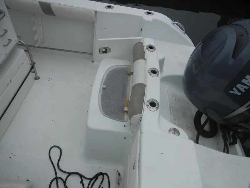 Slide: The Image of 2007 Polar 2100 Center Console boat interior with Yamaha engine and fishing rod holders. - 13